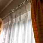 Brown-and-white-pinch-pleated-curtains-inside-a-modern-livng-rom